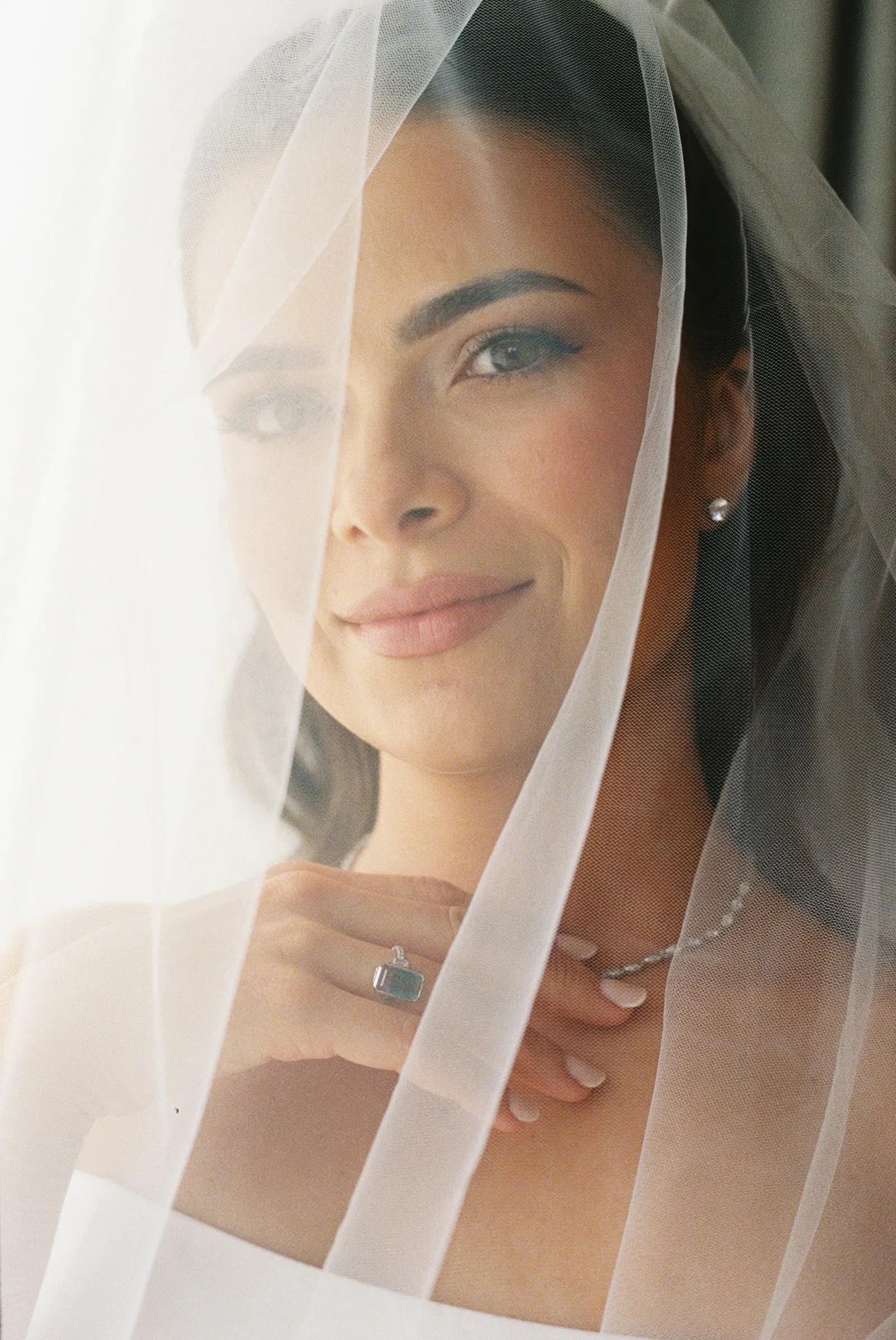 35mm film portrait of a bride looking through her veil