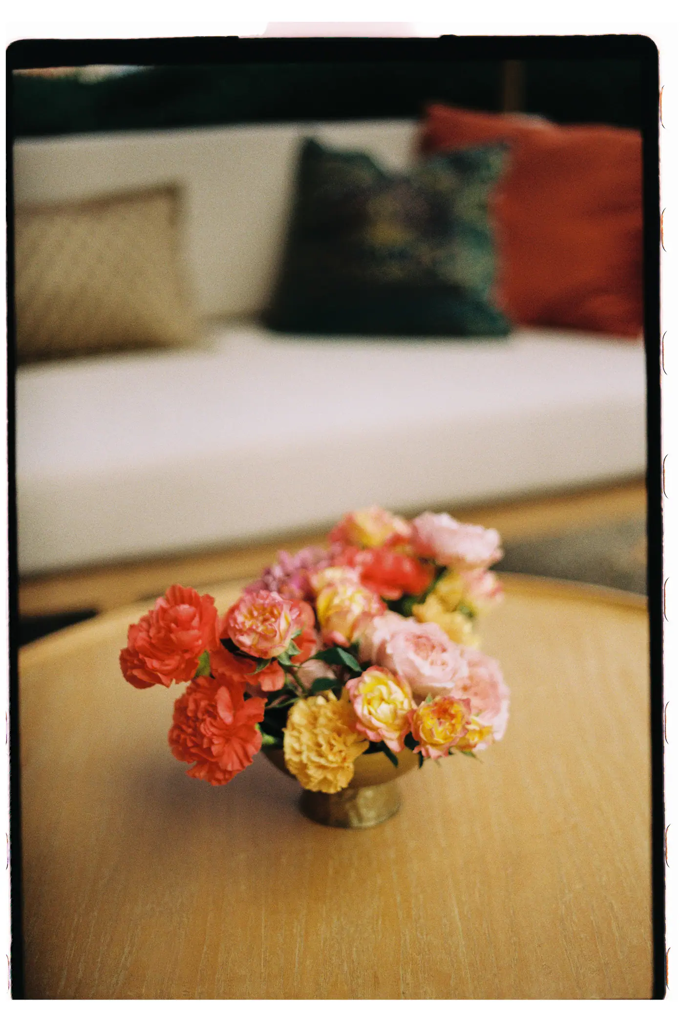 Bouquet of coral and peach roses on a low table