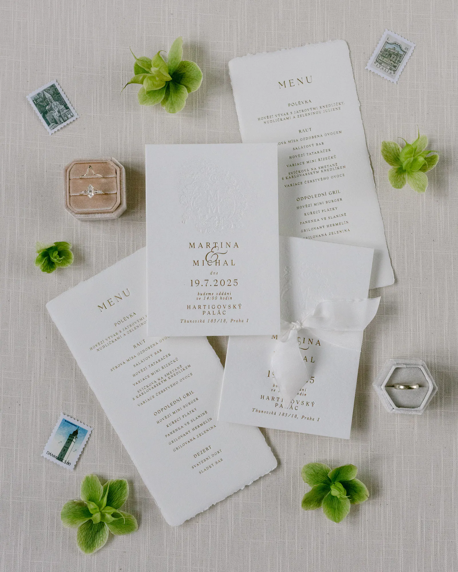 Wedding invitation flat lay with a ring box and green hydrangea